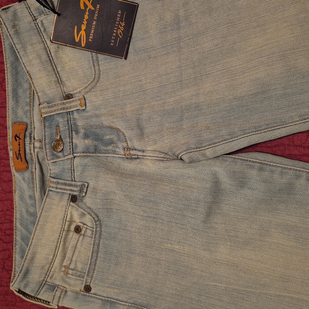 New flare leg jeans. Size 27 . Has tags. Brand "seven7" acid wash light blue.